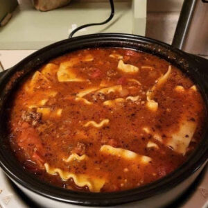 Soup made with layers of pasta, meat, cheese, and tomato sauce.